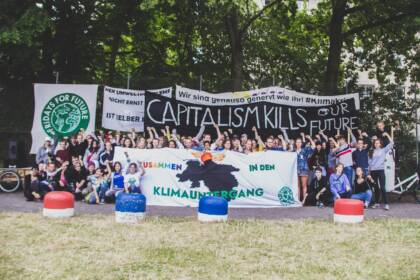 Umweltaktivisten bei Protest mit Bannern im Freien.
